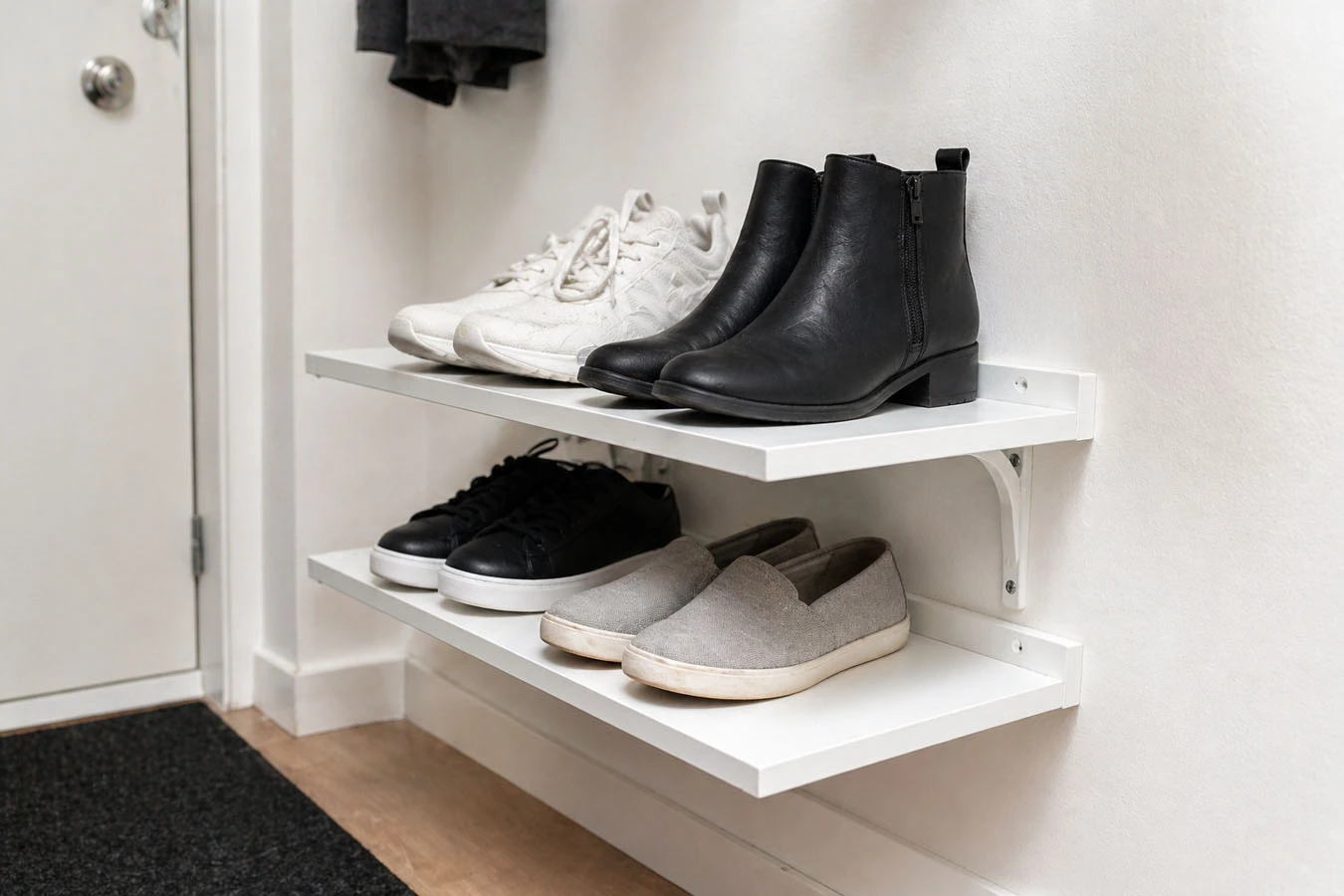 Shoe organization system in a small studio apartment entryway / hallway using adhesive floating shelf