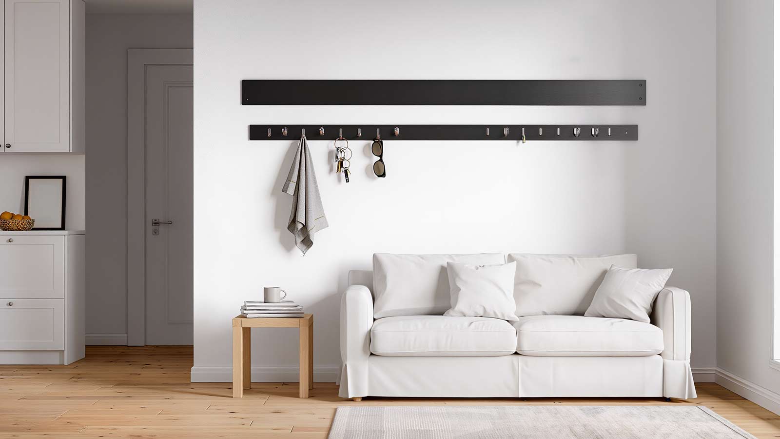 Small studio apartment entryway hallway with peel-and-stick hook rail used as a drop zone for coats, bags, and daily essentials