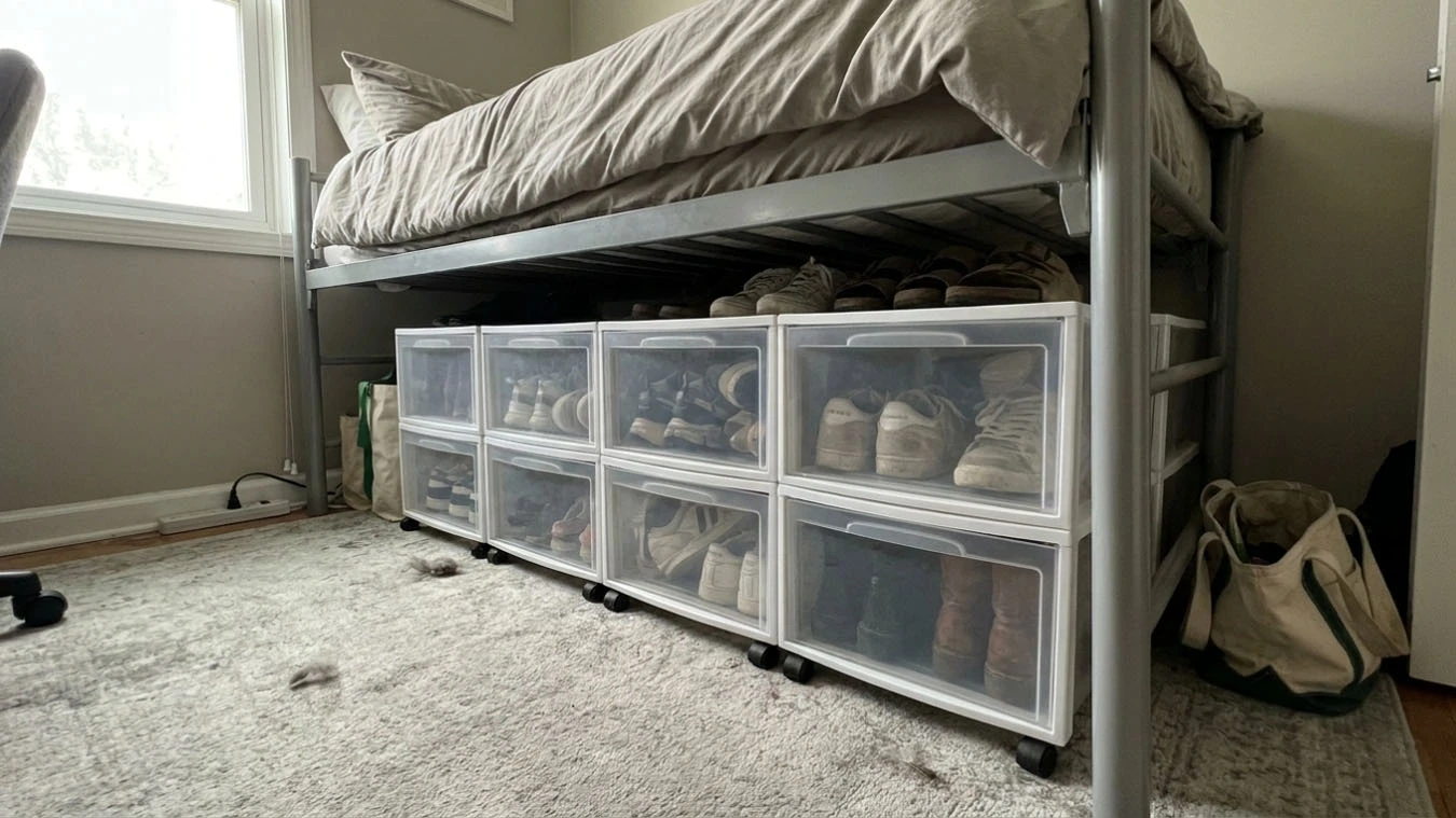 Shoe organization system in a small studio apartment under-bed using rolling drawers
