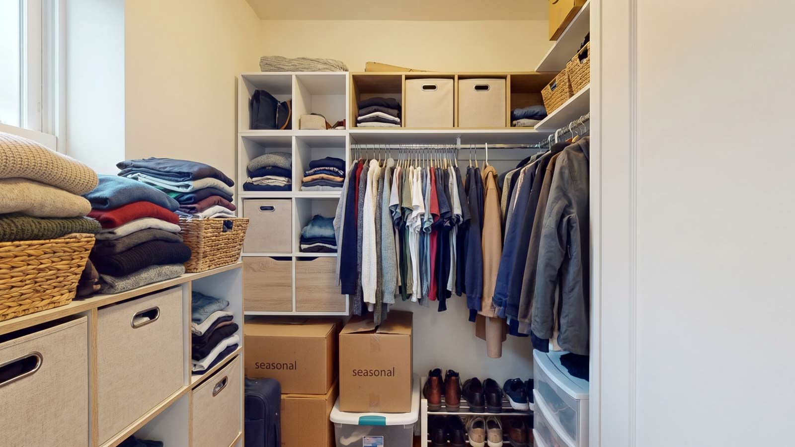 Compact 1-bedroom apartment closet interior featuring a mixed modular system with open and closed storage for clothing and wardrobe overflow